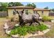 Exterior front view with bull statue in rock garden at 137 Leitha Way, Lakeland, FL 33809