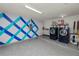 Garage with freshly painted and sealed floor, laundry appliances, and storage shelves at 137 Leitha Way, Lakeland, FL 33809