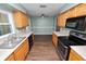 Kitchen featuring light wood cabinets, dark appliances, and ample counter space at 137 Leitha Way, Lakeland, FL 33809
