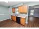 Kitchen featuring light wood cabinets, black appliances, and a view of the adjoining dining area at 137 Leitha Way, Lakeland, FL 33809
