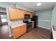 Kitchen featuring light wood cabinets, black appliances, and modern hardware at 137 Leitha Way, Lakeland, FL 33809