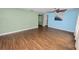 Bright living room featuring wood flooring, a ceiling fan, and multiple access points at 137 Leitha Way, Lakeland, FL 33809