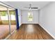 Bright living room with hardwood floors, neutral walls, and sliding doors to a porch at 137 Leitha Way, Lakeland, FL 33809
