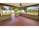 Screened porch featuring painted floors, a ceiling fan and backyard views at 137 Leitha Way, Lakeland, FL 33809