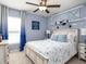 Charming bedroom with blue accents, ceiling fan, and airplane wall decor at 1424 Portmore Dr, Mulberry, FL 33860
