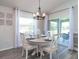 Cozy dining area featuring a round table, four chairs, and an elegant chandelier at 1424 Portmore Dr, Mulberry, FL 33860