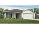 Charming single-story home featuring a well-maintained lawn and an attached two-car garage at 1424 Portmore Dr, Mulberry, FL 33860