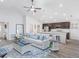 Bright and open living room featuring a ceiling fan, a comfortable sofa, and modern decor at 1424 Portmore Dr, Mulberry, FL 33860