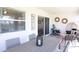 Covered patio with wicker furniture, decorative wall art, and sliding glass door at 1424 Portmore Dr, Mulberry, FL 33860