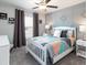 This is a bedroom with decoratively paneled walls, a ceiling fan, carpeted floors, and bright window at 1429 Fleur Dr, Davenport, FL 33837