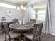 Cozy dining room featuring a wooden table with seating for four, stylish decor, and ample natural light at 1429 Fleur Dr, Davenport, FL 33837