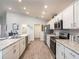 Spacious kitchen with stainless steel appliances, white cabinetry, ample counter space, and an open layout at 1429 Fleur Dr, Davenport, FL 33837