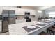 Modern kitchen featuring stainless steel appliances, white cabinets, a large island with seating, and stylish countertops at 1429 Fleur Dr, Davenport, FL 33837