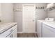 Functional laundry room with modern washer and dryer, storage cabinets, and a countertop for folding clothes at 1429 Fleur Dr, Davenport, FL 33837