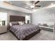 This is a spacious primary bedroom with a ceiling fan, carpeted floors, and a decorative sitting bench at 1429 Fleur Dr, Davenport, FL 33837