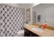Bathroom featuring a granite countertop and a blue patterned shower curtain at 1470 Silver Leaf Dr, Lakeland, FL 33813