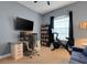 Bedroom featuring a home office setup, bookcase, exercise bike, and natural light at 1470 Silver Leaf Dr, Lakeland, FL 33813