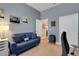 Cozy bedroom featuring a blue couch, neutral carpet, and home office setup at 1470 Silver Leaf Dr, Lakeland, FL 33813