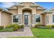 Charming front entrance with stone accents and a well-manicured garden at 1470 Silver Leaf Dr, Lakeland, FL 33813