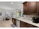 Well lit kitchen has stainless steel appliances, beautiful countertops and sink with a window and hanging lights at 1470 Silver Leaf Dr, Lakeland, FL 33813