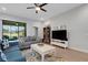 Cozy living room with a ceiling fan, comfortable seating, and sliding glass door at 1470 Silver Leaf Dr, Lakeland, FL 33813