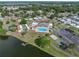 Community aerial view with pool, shuffleboard, tennis, and pickleball near a lake at 1642 Tally Ho Dr, Lakeland, FL 33810