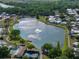 Aerial shot of a community with a lake featuring a central fountain at 1642 Tally Ho Dr, Lakeland, FL 33810