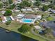 Beautiful aerial view of community amenities including a pool, tennis court, and lake with dock access at 1642 Tally Ho Dr, Lakeland, FL 33810