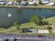 Scenic aerial view of a tranquil lake with a fountain and recreational facilities in a vibrant community at 1642 Tally Ho Dr, Lakeland, FL 33810