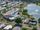 Comprehensive aerial view showcasing community amenities, including a pool, tennis courts, and a serene lake at 1642 Tally Ho Dr, Lakeland, FL 33810