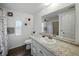 Well-lit bathroom featuring a single vanity with a granite countertop and updated mirror at 1642 Tally Ho Dr, Lakeland, FL 33810