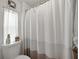 Bathroom featuring a toilet and white shower curtain near the window at 1642 Tally Ho Dr, Lakeland, FL 33810