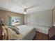 Inviting bedroom featuring a queen-sized bed, ceiling fan, and a relaxing atmosphere at 1642 Tally Ho Dr, Lakeland, FL 33810