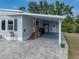 View of a home's carport featuring brick pavers and a covered entrance at 1642 Tally Ho Dr, Lakeland, FL 33810