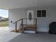 Under-the-carport entrance featuring a white door with decorative oval window at 1642 Tally Ho Dr, Lakeland, FL 33810
