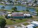 Expansive community center with a pool overlooking a picturesque lake, enhancing the neighborhood charm at 1642 Tally Ho Dr, Lakeland, FL 33810