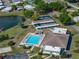 Aerial view showcasing the community pool, tennis courts, and lake enhancing community appeal at 1642 Tally Ho Dr, Lakeland, FL 33810