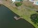 Aerial view of a wooden dock on a serene lake in a well-maintained community at 1642 Tally Ho Dr, Lakeland, FL 33810