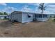 Side view of home with screened patio and lawn at 1642 Tally Ho Dr, Lakeland, FL 33810