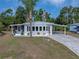 Charming single-story home featuring a well-manicured lawn, carport and a covered front porch at 1642 Tally Ho Dr, Lakeland, FL 33810