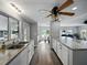 Modern kitchen with granite counters, white cabinets, stainless steel appliances, and hardwood flooring at 1642 Tally Ho Dr, Lakeland, FL 33810