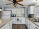 Bright kitchen features white cabinetry, stainless appliances, granite counters and wood-look flooring at 1642 Tally Ho Dr, Lakeland, FL 33810