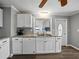 Updated kitchen with stainless dishwasher, granite counters, stainless sink, and white cabinets at 1642 Tally Ho Dr, Lakeland, FL 33810