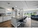Well-lit kitchen featuring a large island, white cabinets, appliances, and an open layout to the living space at 1642 Tally Ho Dr, Lakeland, FL 33810
