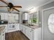 Updated kitchen with granite counters, stainless sink, white cabinetry, and pendant lighting at 1642 Tally Ho Dr, Lakeland, FL 33810