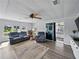 Cozy living room with hardwood floors, ceiling fan, sliding glass doors, and comfortable seating at 1642 Tally Ho Dr, Lakeland, FL 33810