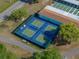 Aerial view of four well-maintained outdoor pickleball courts within the community at 1642 Tally Ho Dr, Lakeland, FL 33810