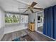 Cozy sunroom featuring lots of windows, vinyl floors and a view into the kitchen at 1642 Tally Ho Dr, Lakeland, FL 33810