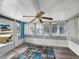 Bright sunroom with lots of natural light, updated floors, and a charming ceiling fan at 1642 Tally Ho Dr, Lakeland, FL 33810