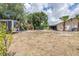 Large backyard with mature trees, swing set, and utility trailer for storing your recreational equipment at 1808 Stonecrest Ct, Lakeland, FL 33813